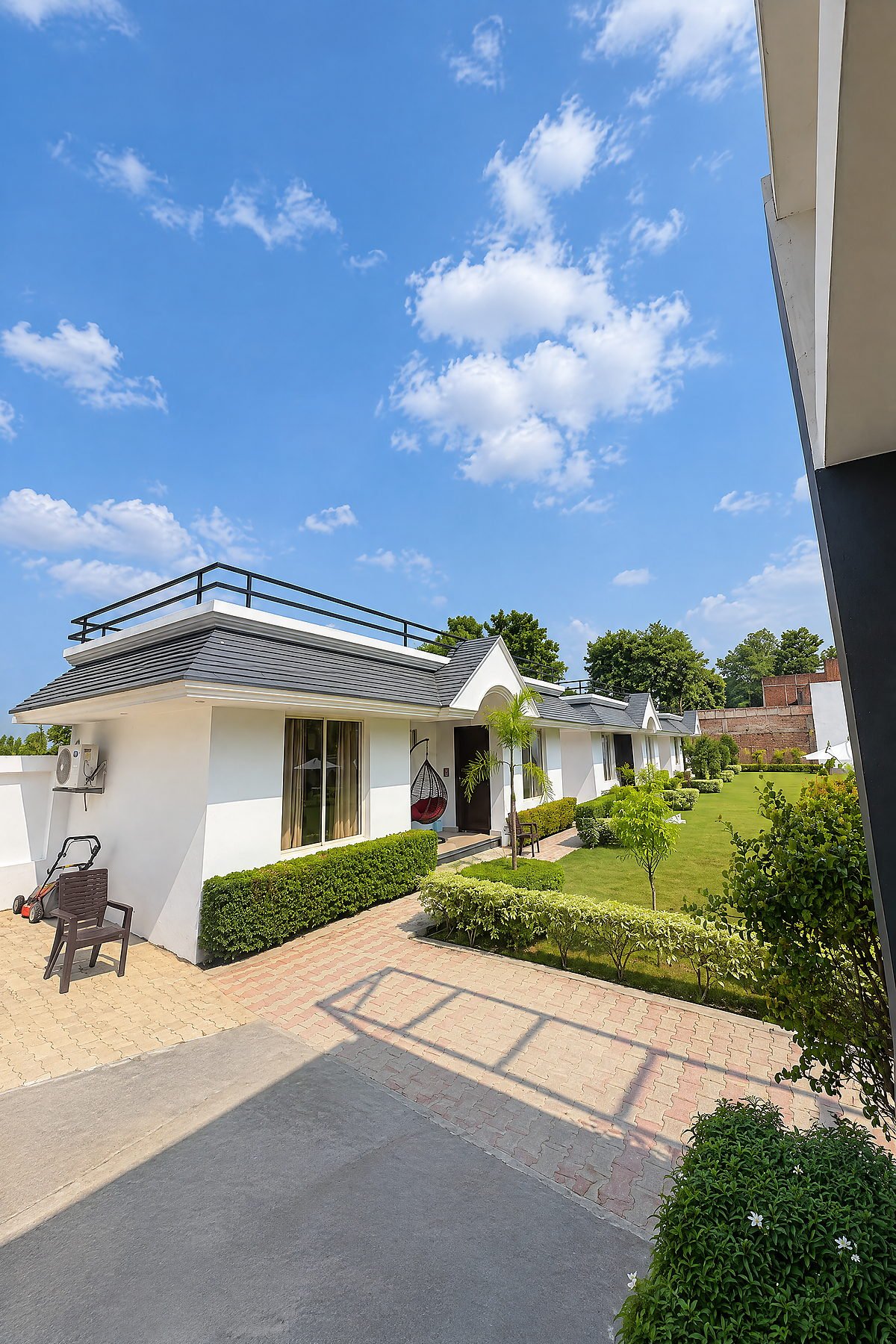Exterior of the guest cottages under a bright sky at The White House Pilibhit