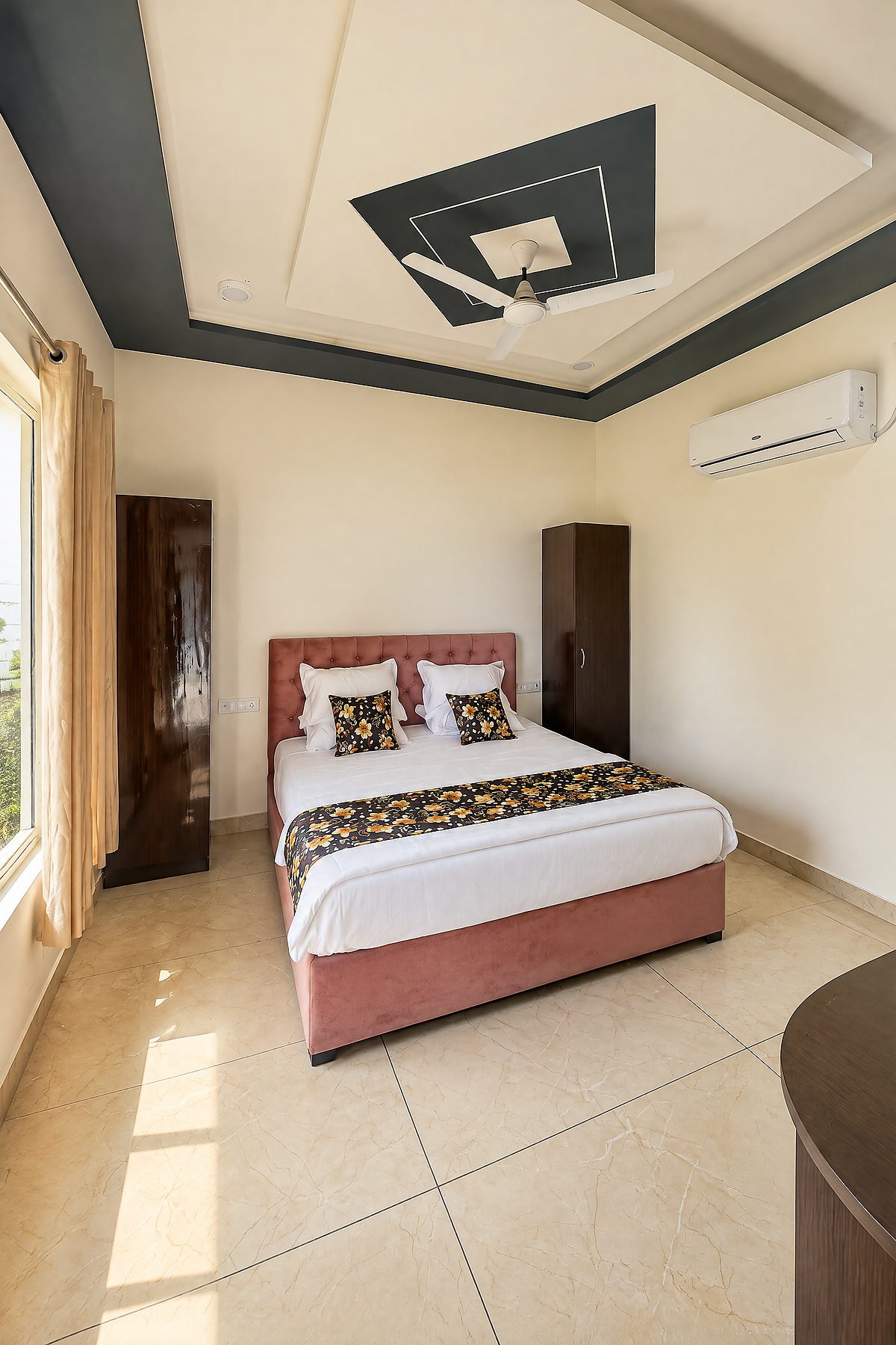Guest room with a double bed, wardrobe and air conditioning at The White House Pilibhit