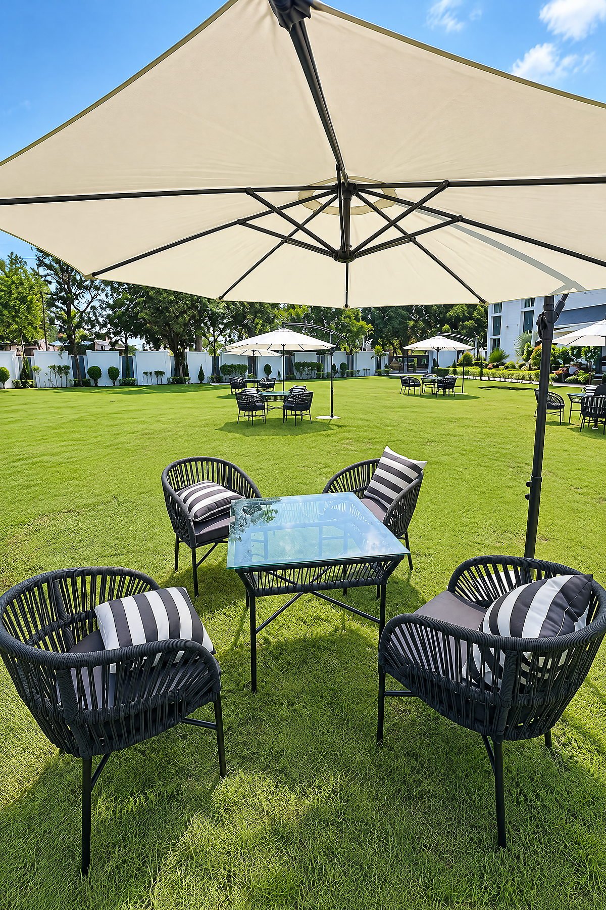 Parasol, table and chairs set up on the lawn at The White House Pilibhit