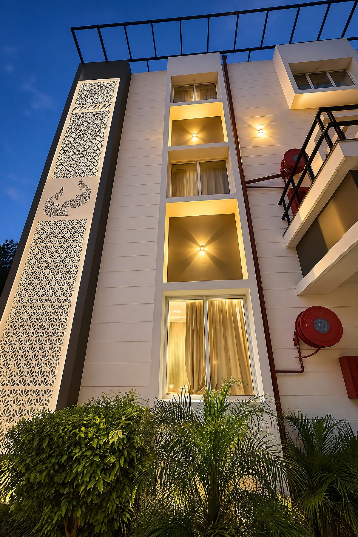 The modern multi-level block of The White House Pilibhit lit at night